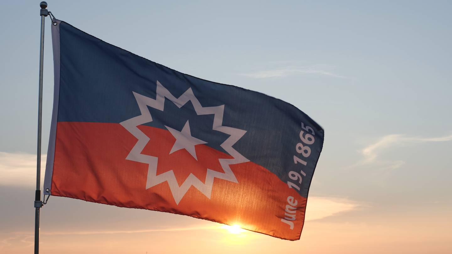 Juneteenth flag with sun shining behind it